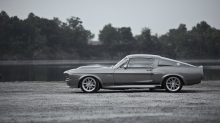 Серый Ford Mustang Eleanor на берегу спокойной реки